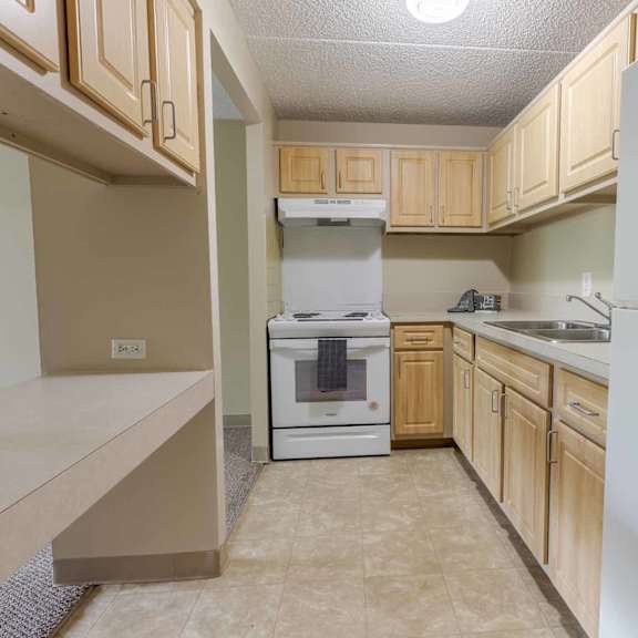 a kitchen with a white oven and a white refrigerator.