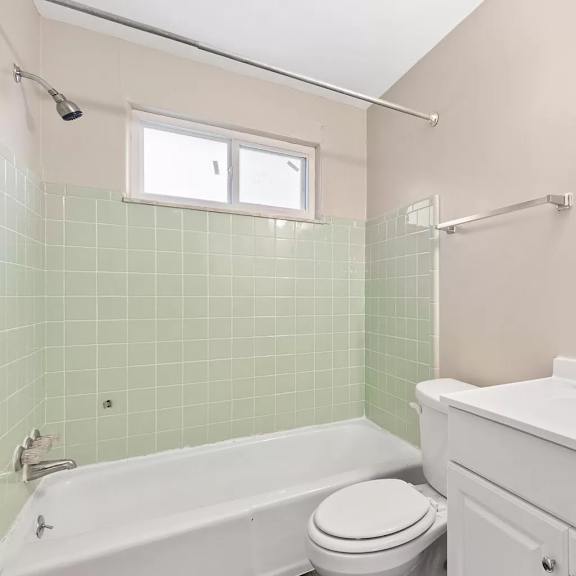 a bathroom with a sink toilet and a bath tub
