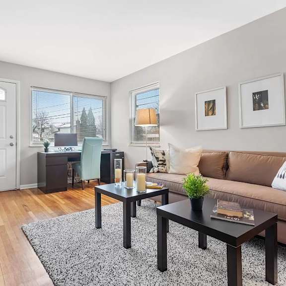 a living room with a couch and tables