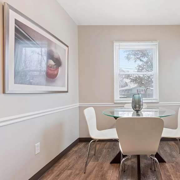 a dining room with a table and chairs and a window