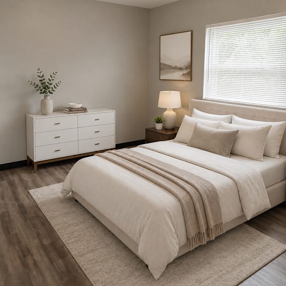 a bedroom with a bed, nightstand, and a dresser.