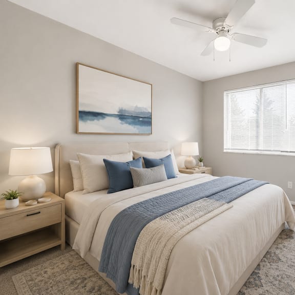 a bedroom with a bed, a ceiling fan, and a painting on the wall.