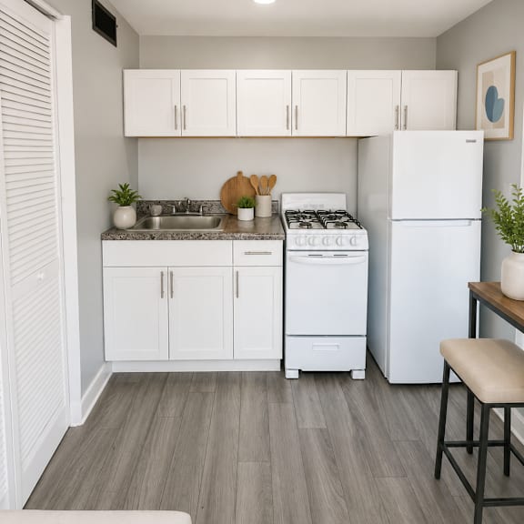 a kitchen with white cabinets and a white refrigerator.