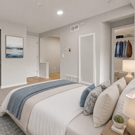 a bedroom with a large bed and a painting on the wall.