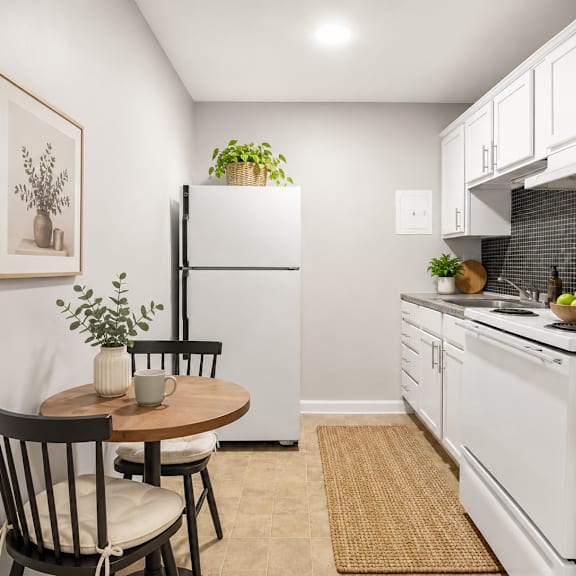 a kitchen with a table and chairs and a fridge.