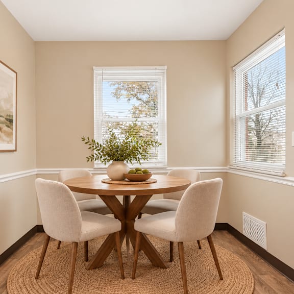 a dining room with a table and chairs.