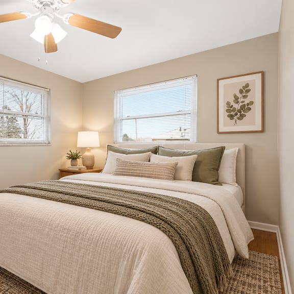 a bedroom with a large bed and a ceiling fan.