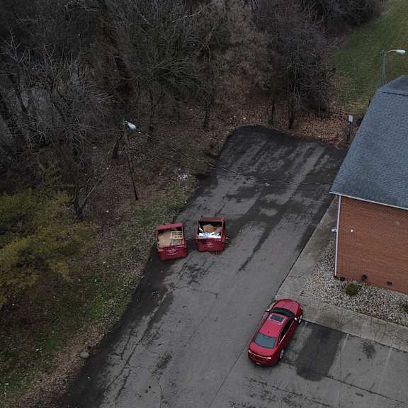 two red cars are parked in a parking lot.