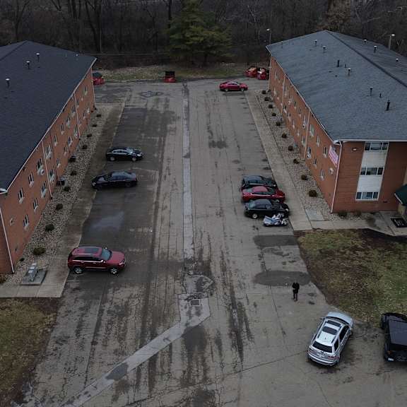 a parking lot with cars parked in front of a building.