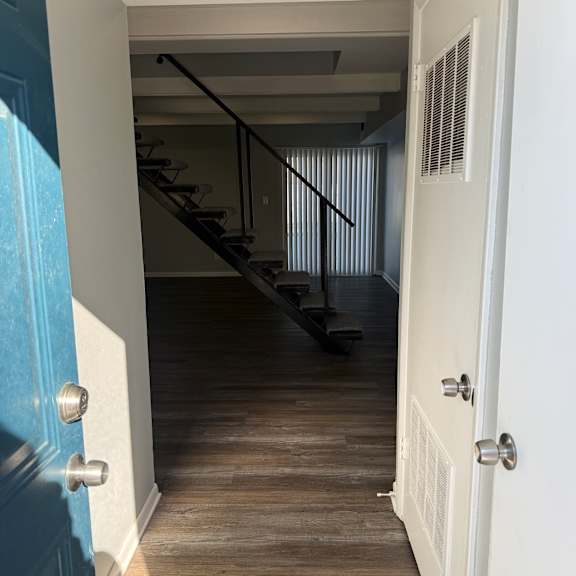 a room with a staircase and a wooden wall.