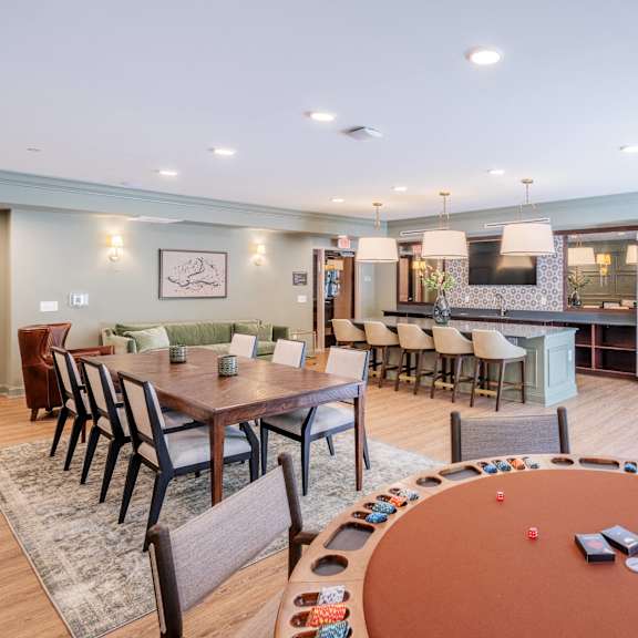 a clubhouse with a poker table and a kitchen