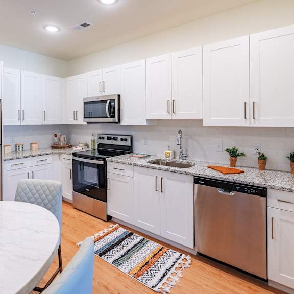 kitchen with stainless steel appliances and white cabinets