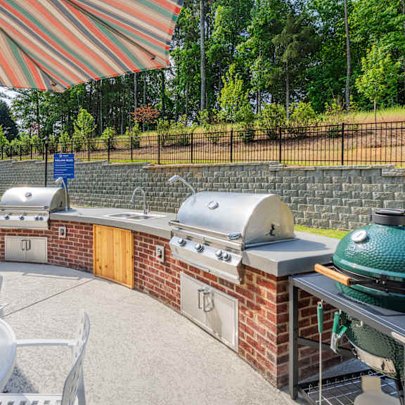 patio with outdoor dining and grilling stations at arden at huntersville