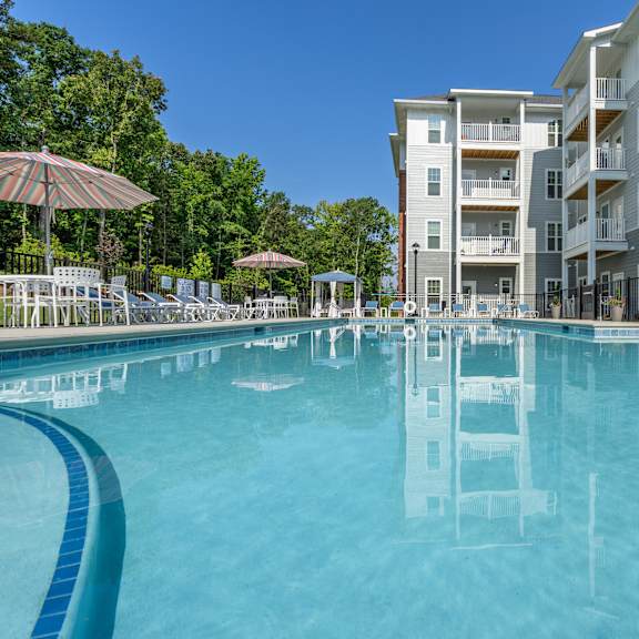 swimming pool outside the arden at huntersville 55+ community apartment building