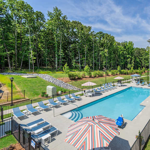 arden at huntersville 55+ community swimming pool surrounded by lounge chairs