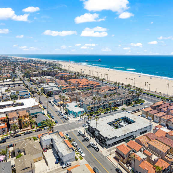 a beachfront city with a clear blue sky and ocean.
