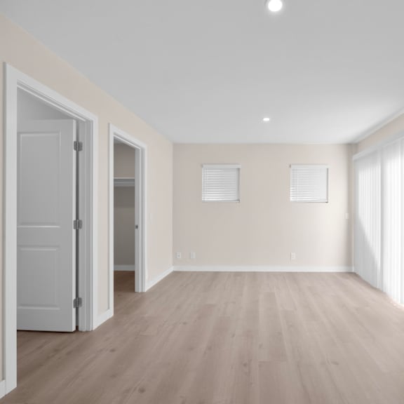 a room with wooden floors and white walls.