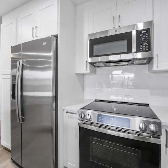 a modern kitchen with a stainless steel refrigerator and oven at tamarack sands apartment homes, carlsbad, ca