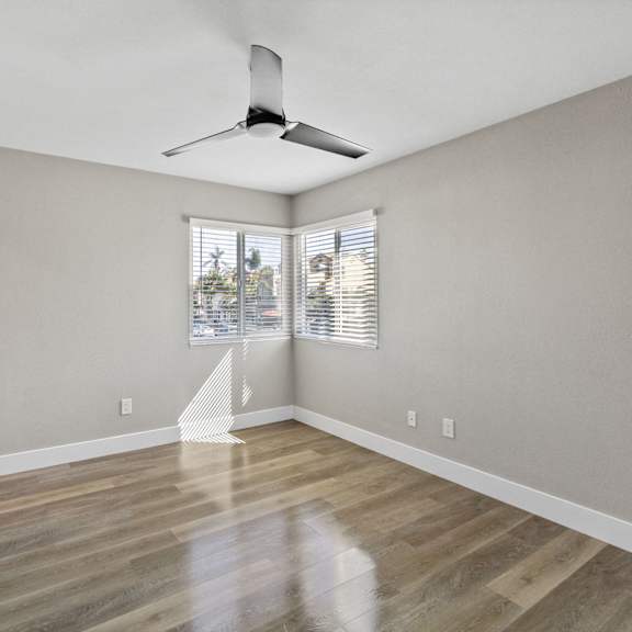 bedroom with ceiling fan at ocean breeze terrace apartment, huntington beach