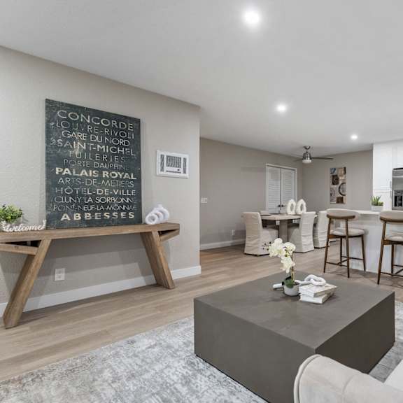 a living room with a coffee table and a chalkboard on the wall at tamarack sands apartment homes, carlsbad, ca, 92008