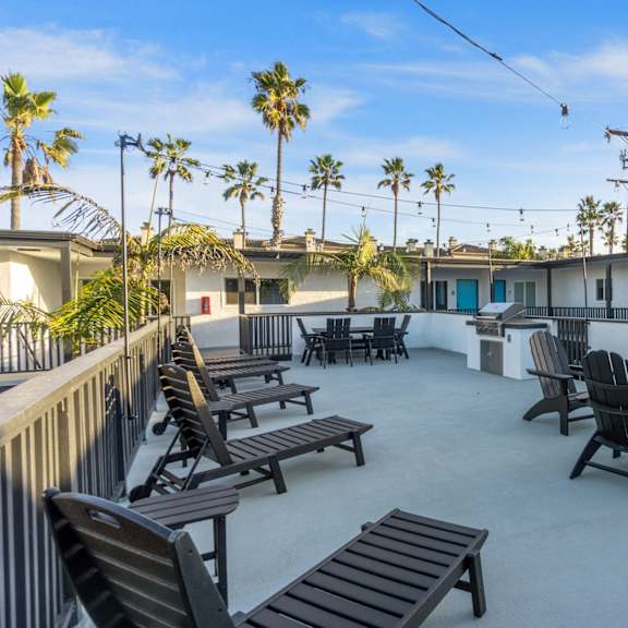 deck with bbq and seating at ocean breeze terrace apartment, huntington beach, ca
