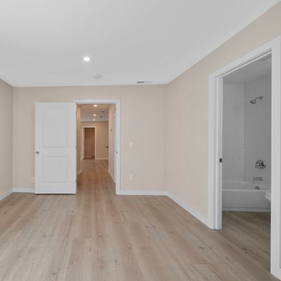 a room with wooden floors and white walls.