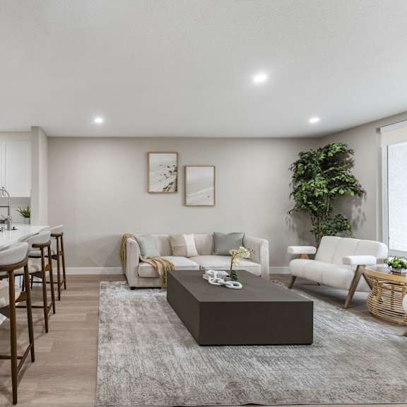 a modern kitchen with white cabinets and a large island at tamarack sands apartment homes, carlsbad, 92008