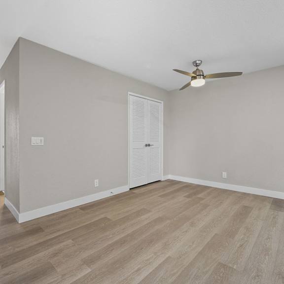 a room with a ceiling fan and light fixture at tamarack sands apartment homes, california