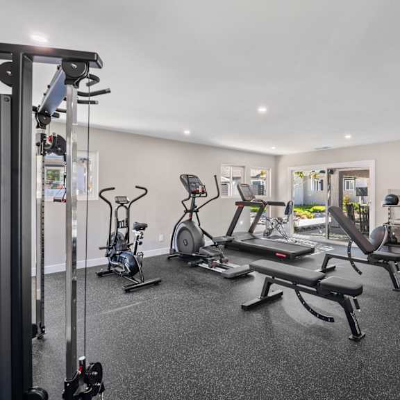 a well-equipped gym with a variety of exercise machines.