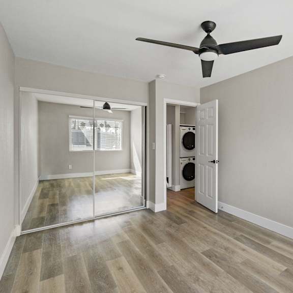 a living room with white walls and wood floors at ocean breeze terrace apartment, huntington beach, california