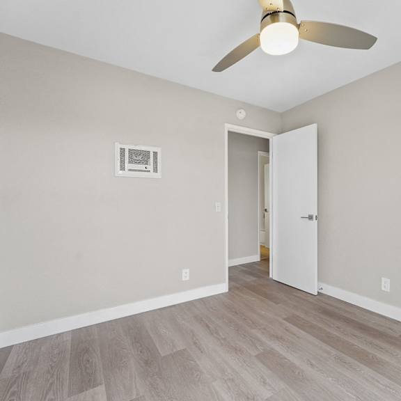a room with a ceiling fan and a door at tamarack sands apartment homes, california, 92008