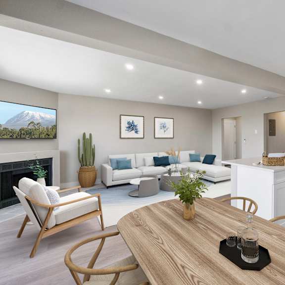 a modern living room with a fireplace and a dining area.at ocean edge @ laguna beach, california