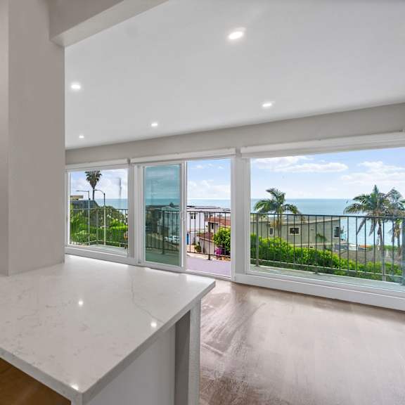 a modern kitchen with a large island at ocean edge @ laguna beach, laguna beach, ca