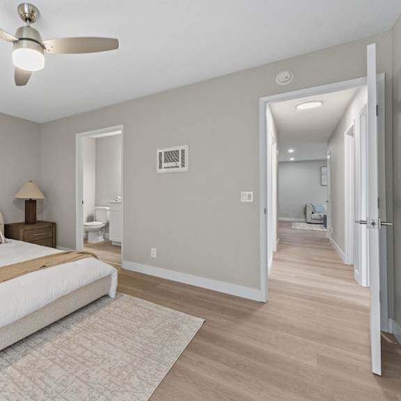 a bedroom with a large bed and a ceiling fan at tamarack sands apartment homes, carlsbad, 92008