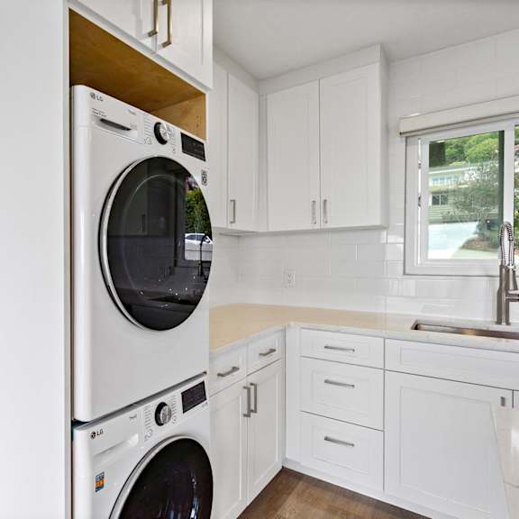 a white washing machine in a kitchen.at ocean edge @ laguna beach, california, 92651