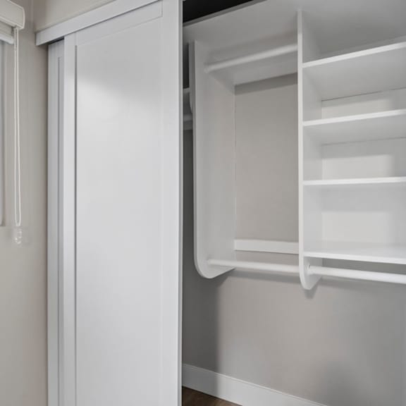 a white refrigerator with the door open and shelves inside.