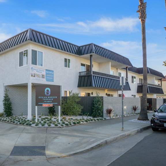 a building with a sign at ocean breeze terrace apartment, huntington beach, ca