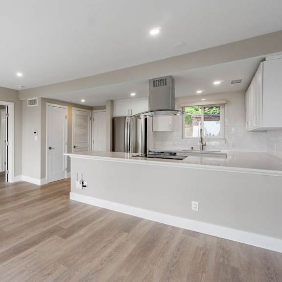 a kitchen with a refrigerator, sink, and cabinets.at ocean edge @ laguna beach, laguna beach