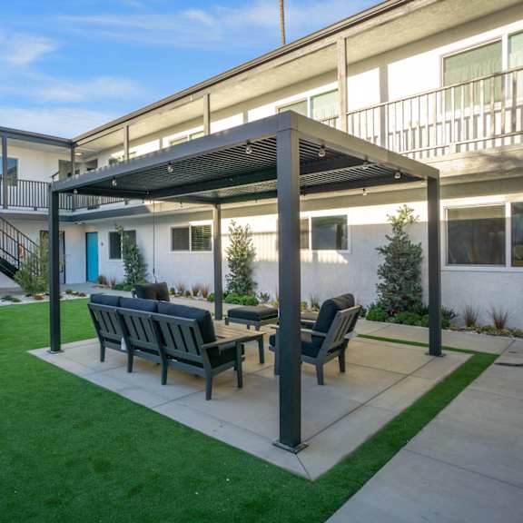 pergola with seating at ocean breeze terrace apartment, california, 92648