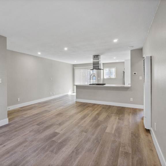 renovated kitchen and living room at ocean breeze terrace apartment, huntington beach, ca
