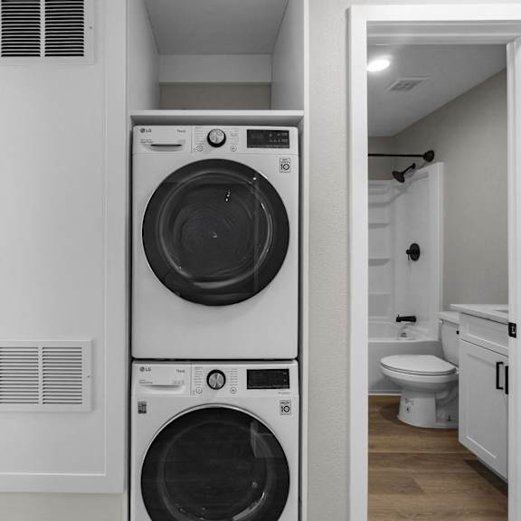 a small laundry room with a washing machine and a dryer at ocean breeze terrace apartment, huntington beach, california