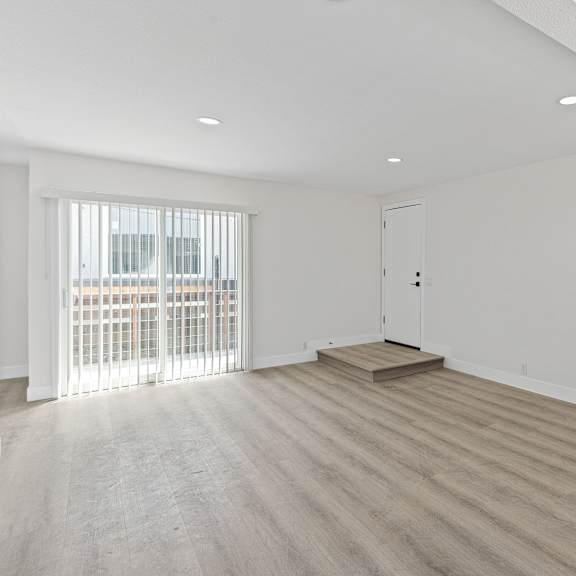 a bedroom with hardwood floors and white walls at seaview terrace apartment homes, san clemente, ca, 92672