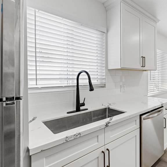 a kitchen with white cabinets and a stainless steel dishwasher at seaview terrace apartment homes, san clemente, ca, 92672