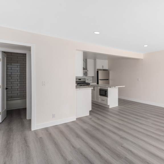 a kitchen and living room in a 555 waverly unit at seaview terrace apartment homes, san clemente, ca