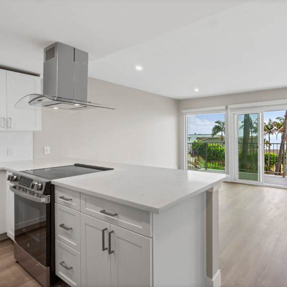 a modern kitchen with a stainless steel oven and a marble countertop.at ocean edge @ laguna beach, california, 92651