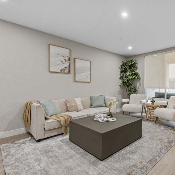 a living room with a couch, coffee table, and two chairs at tamarack sands apartment homes, carlsbad, ca