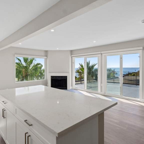 a modern kitchen with a large island and a view of the oceanat ocean edge @ laguna beach, laguna beach, ca.