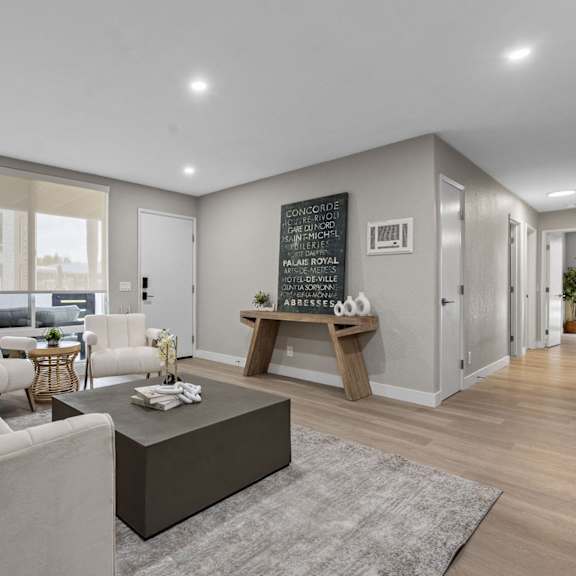 a living room with a couch, coffee table, and a plant at tamarack sands apartment homes, california, 92008