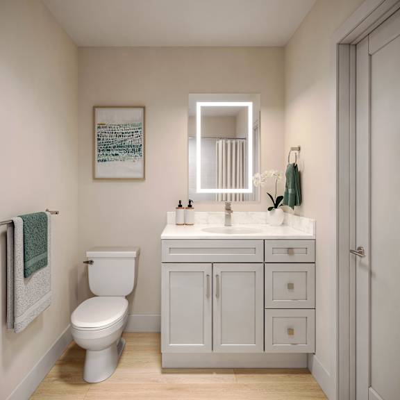 a white toilet sits next to a white sink in a small bathroom.
