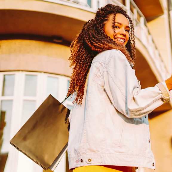 resident enjoying shopping with bags at nineteen90 apartment homes, costa mesa, ca 92627